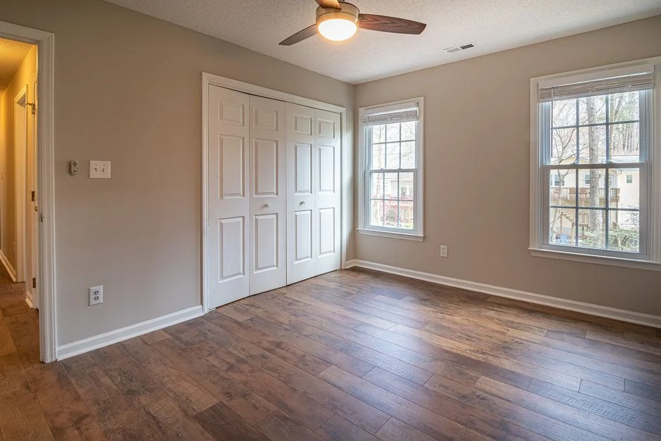 A person standing in a room surrounded by moving boxes labeled for the kitchen.